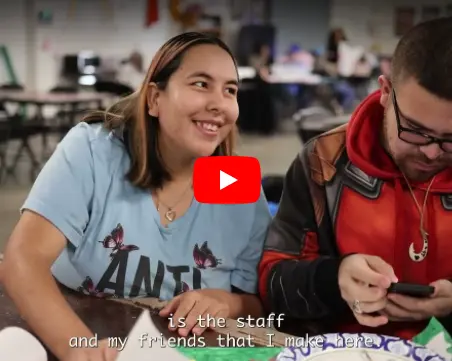 Photo of two individuals, one smiling and the other lookng at his phone at club 194