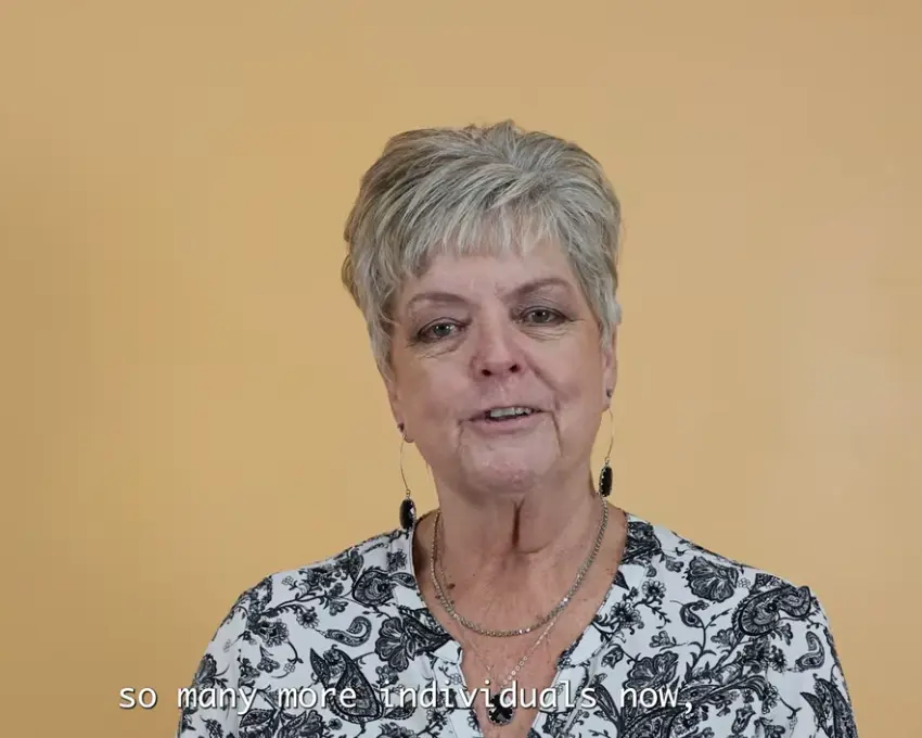 Val, a PSW staff member, smiling during her interview for the video featured on this page.